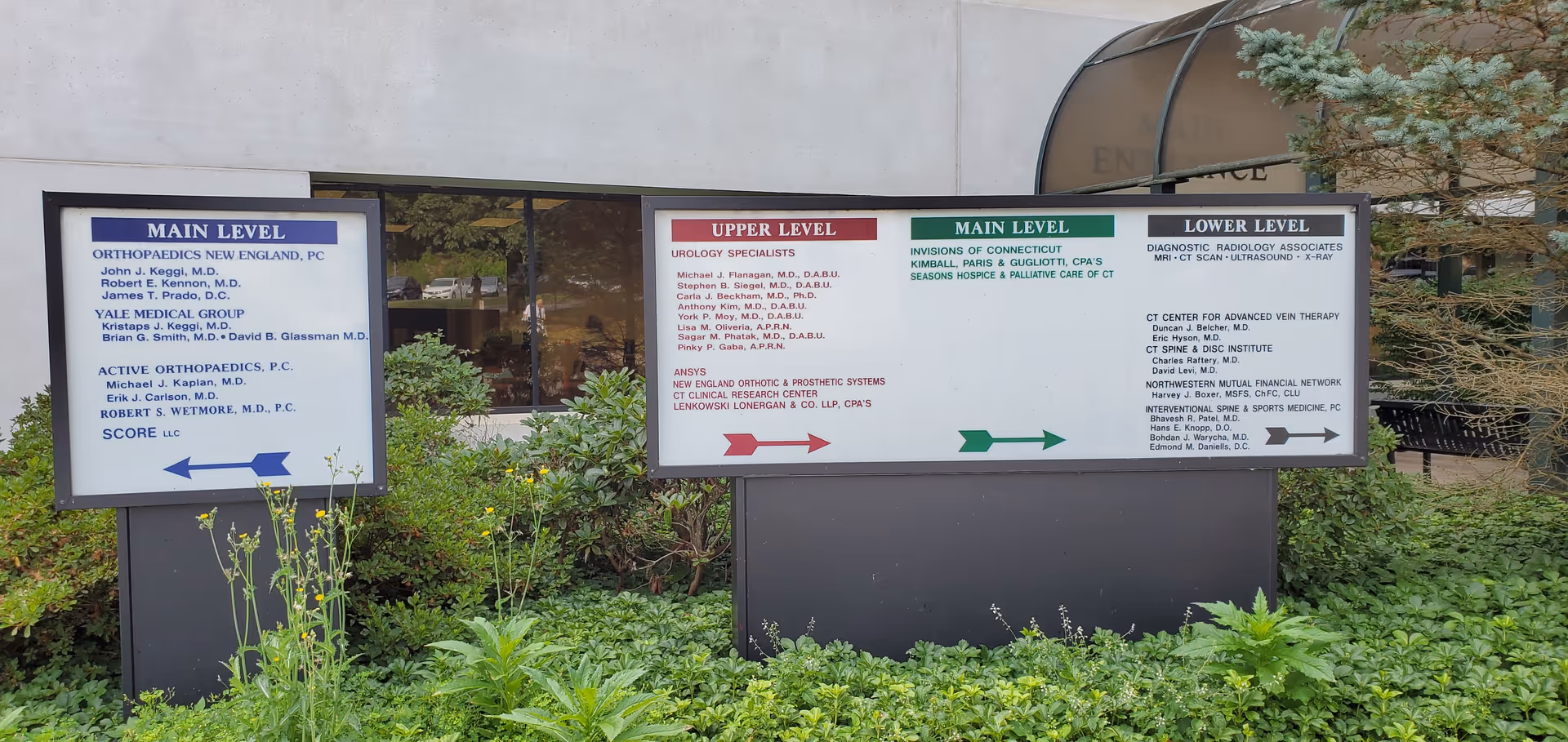 Exterior signs for AccentCare Hospice-Connecticut with level directories in a landscaped area.