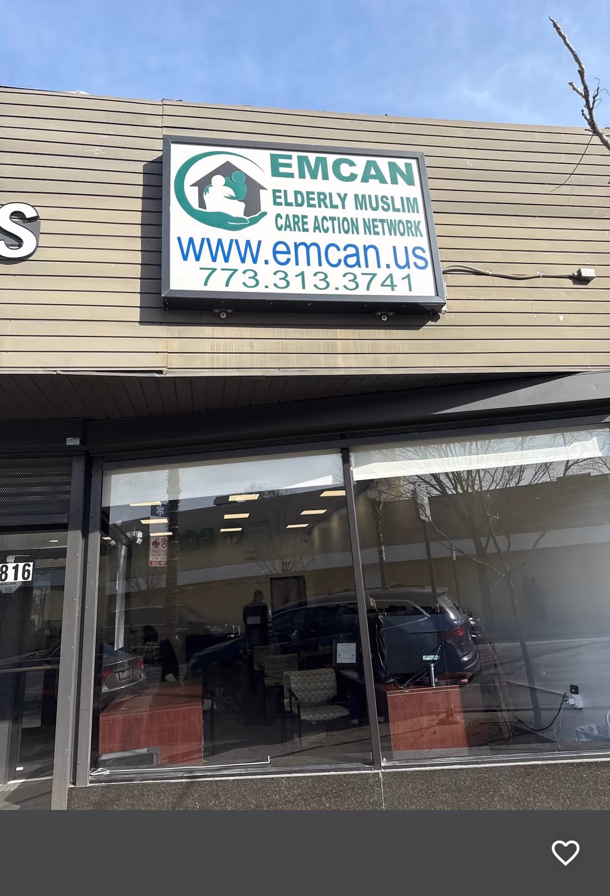 Exterior view of EMCAN Elderly Muslim Care Action Network sign above glass storefront entrance.