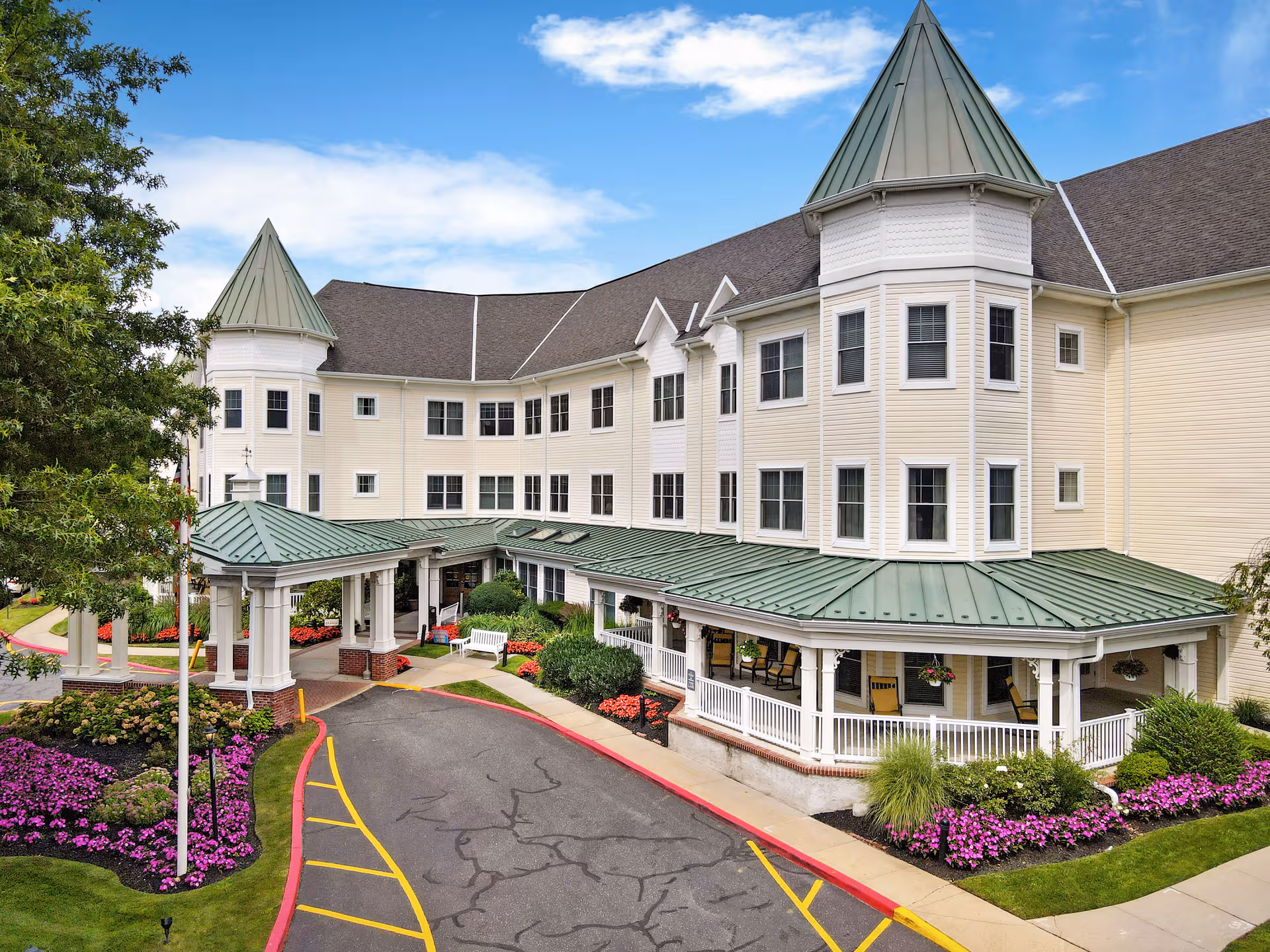 Sunrise of Glen Cove exterior with a green-roofed entrance and landscaped front.