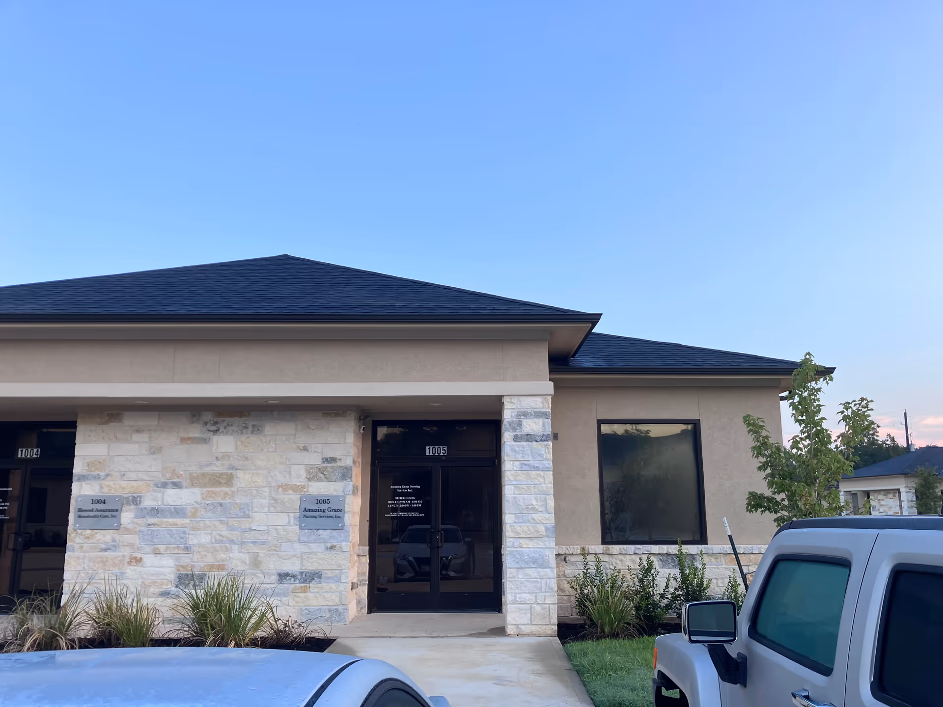 Exterior view of Amazing Grace Nursing Services facility with stone facade and glass entrance.