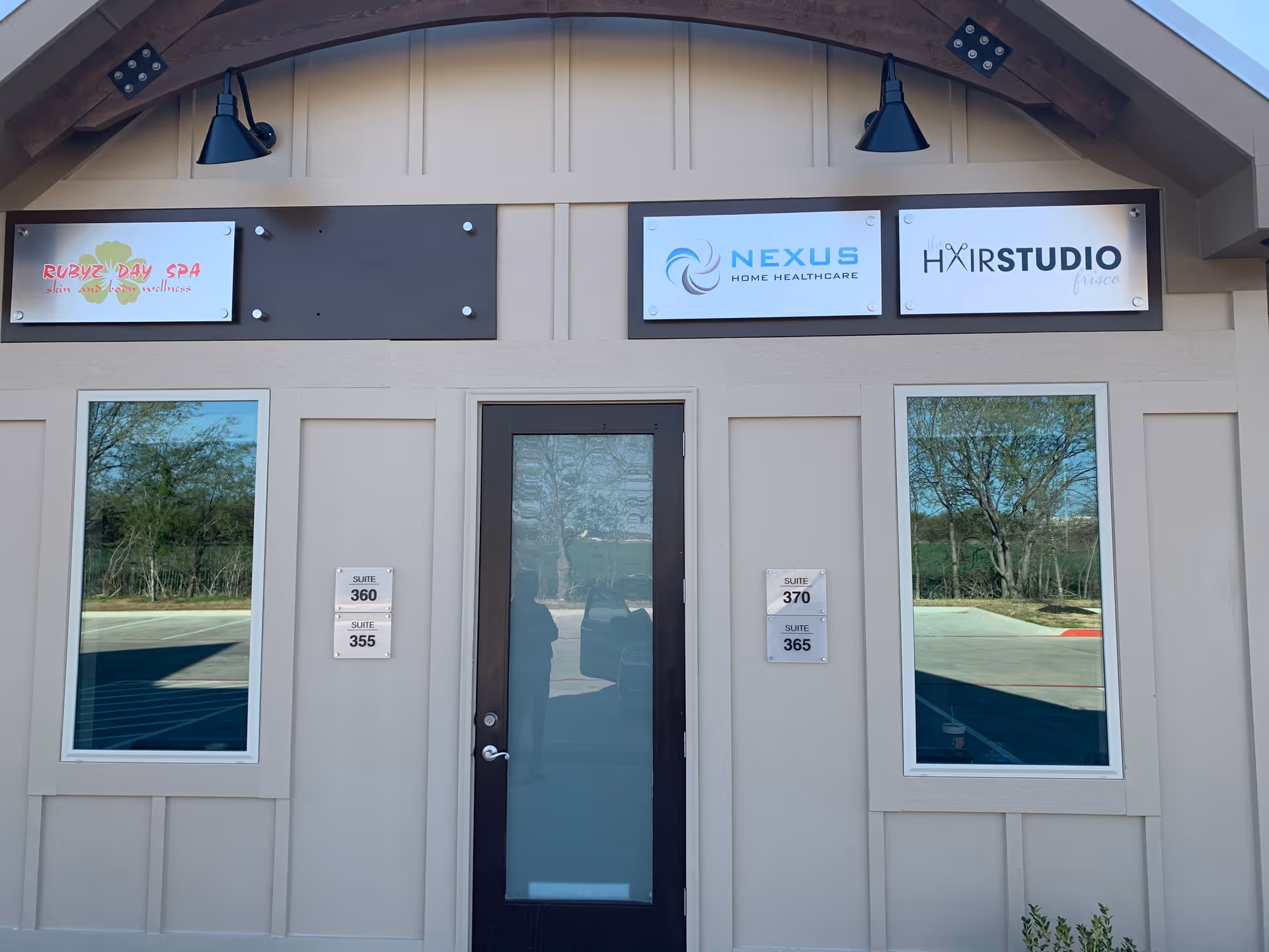 Front of a beige building with Nexus Home Healthcare sign, door, and two large windows.