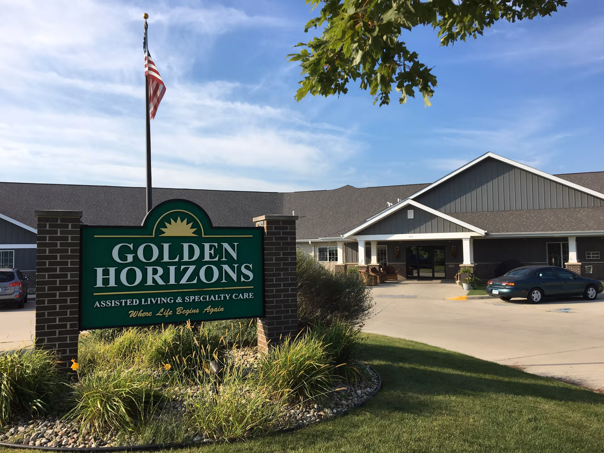 Front view of Golden Horizons senior living facility in Ida Grove with entrance and sign.