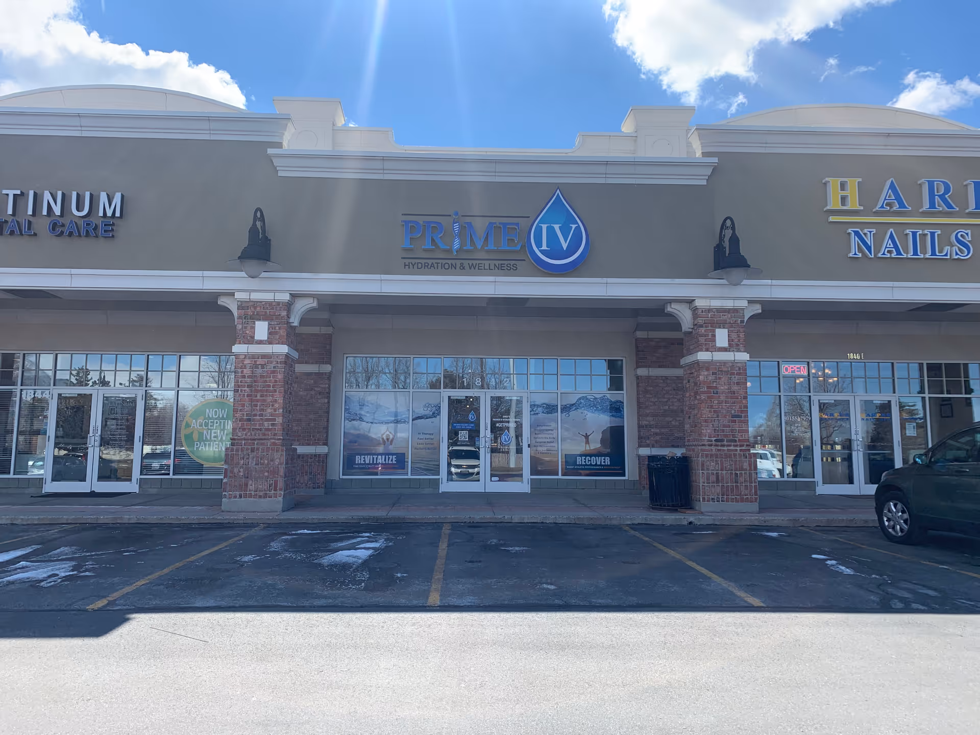 Exterior view of Prime IV Hydration and Wellness storefront in Sandy, with signage and glass doors.
