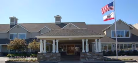 Brookdale Lodi senior living center exterior with entrance canopy and flagpoles