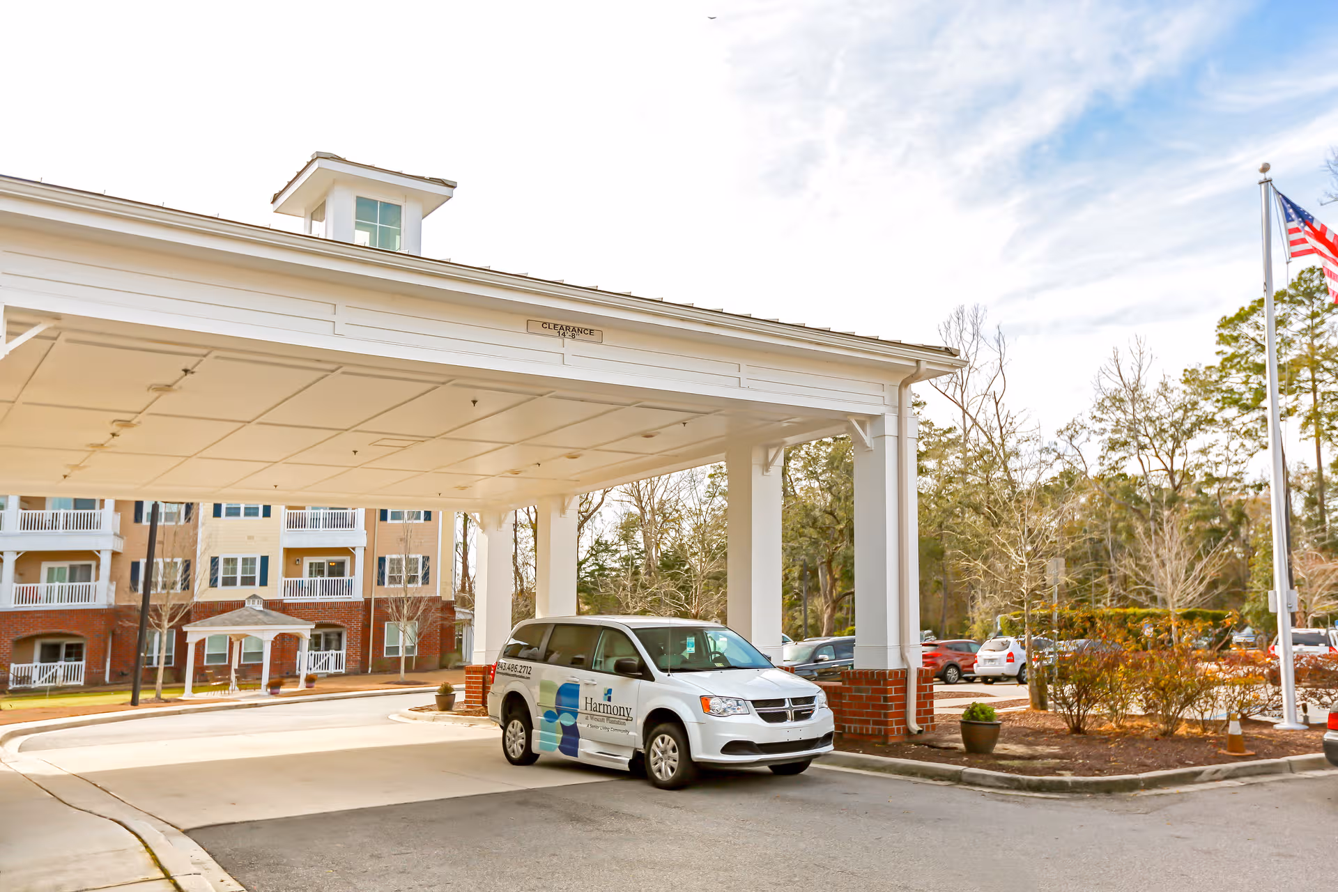 Entrance canopy of Harmony at Wescott with a service van parked outside.