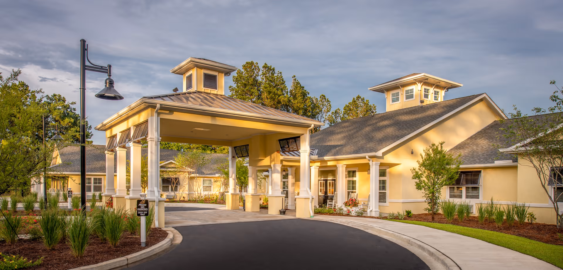 Exterior view of The Addison of West Ashley with a covered entrance and driveway.