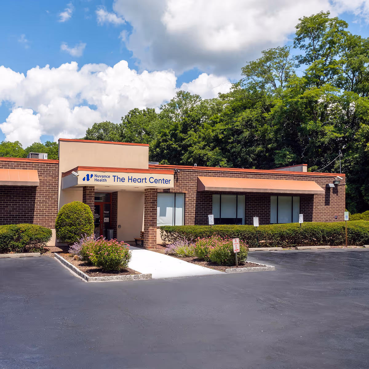 Nuvance Health The Heart Center exterior storefront with brick facade and landscaping.