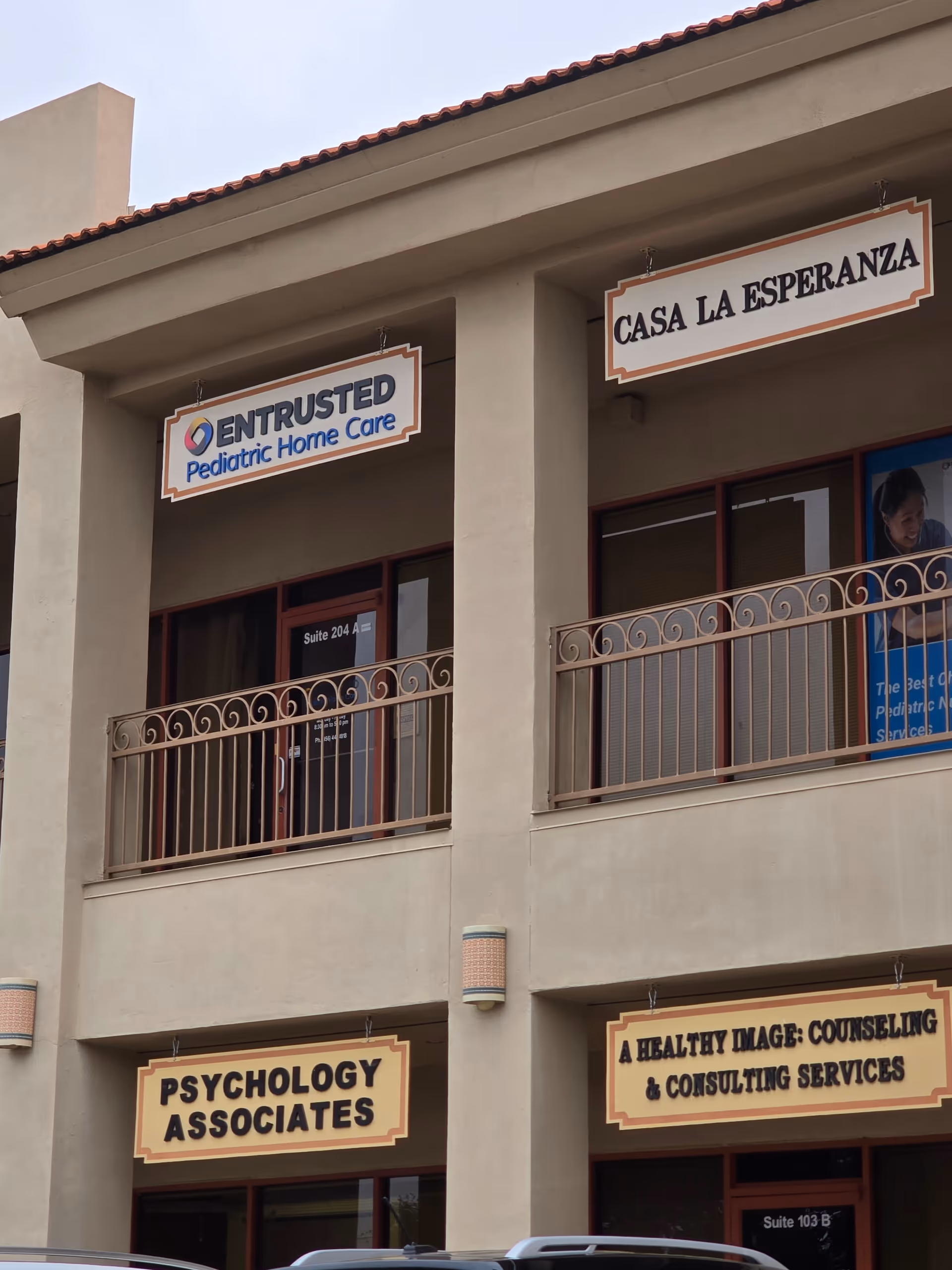 Exterior view of a beige building with Entrusted Pediatric Home Care sign.