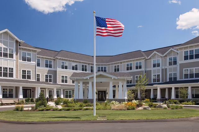 Front exterior view of The Residence at South Windsor Farms with American flag.