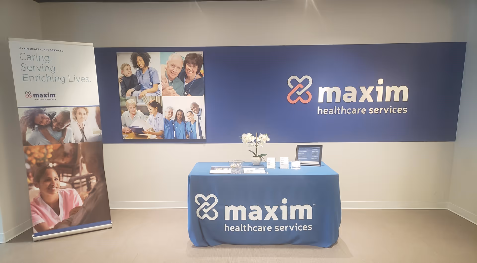 Blue table with Maxim Healthcare Services banner in a reception area.