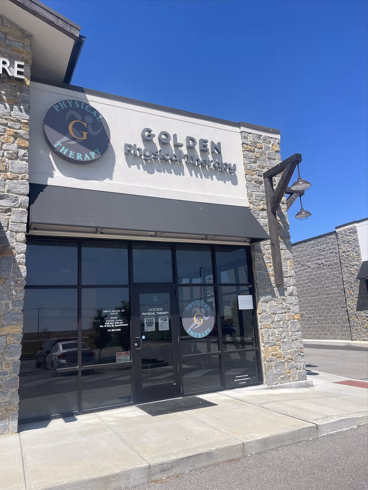 Front view of Golden Physical Therapy storefront with stone facade and glass entrance doors.