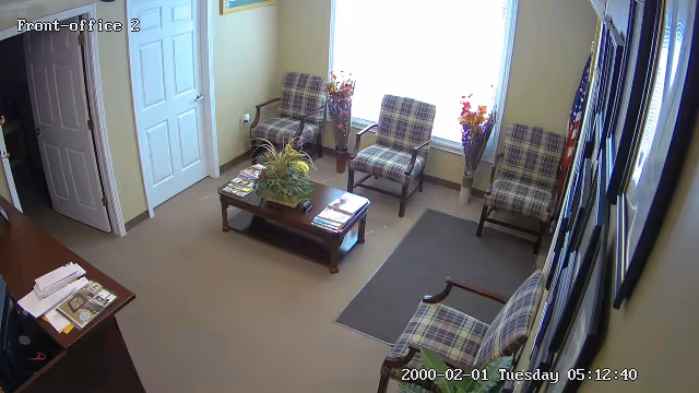 Interior waiting area in a senior facility with plaid chairs and plants.