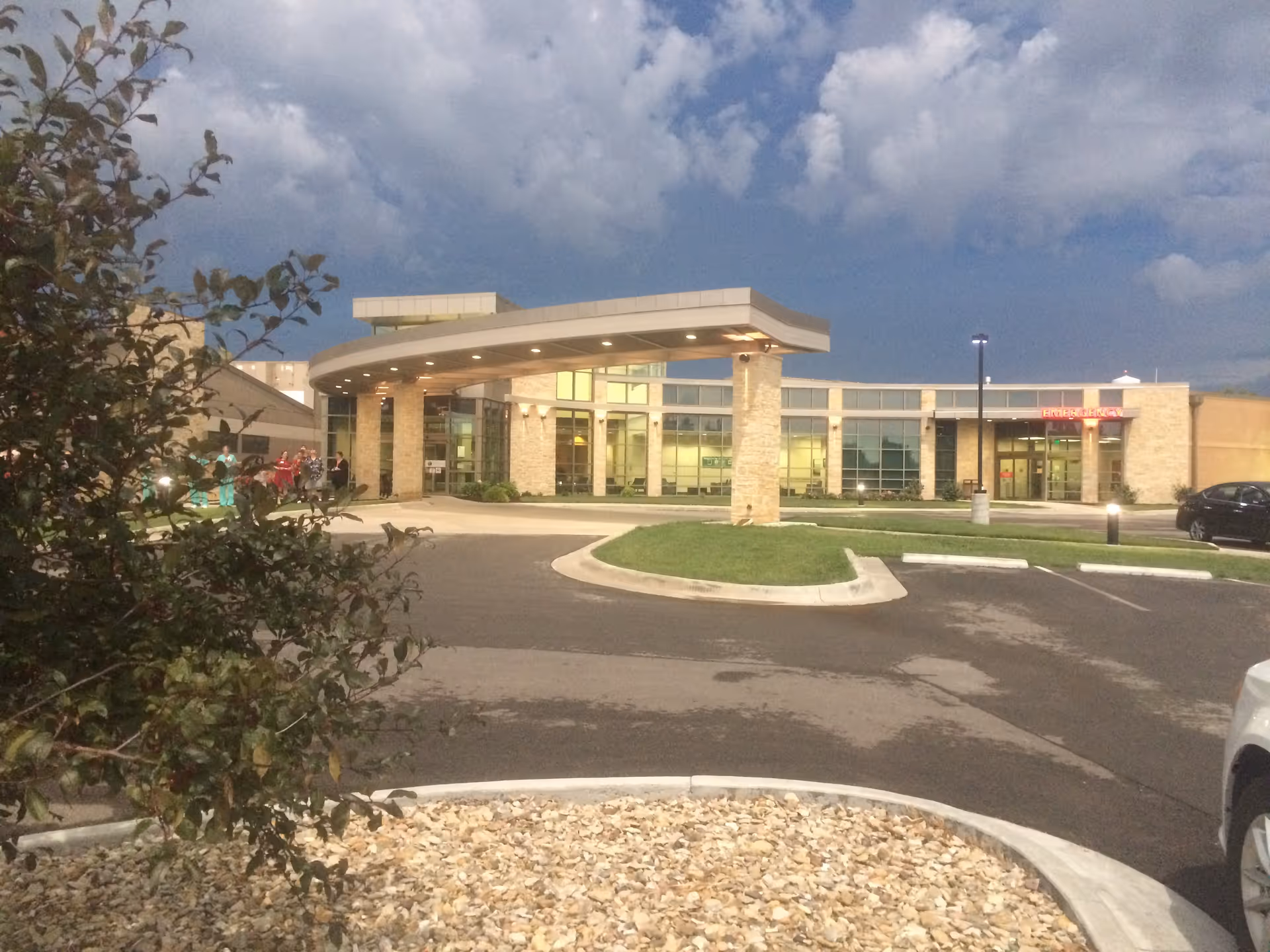 Exterior view of Community HealthCare System facility with a curved entrance canopy.
