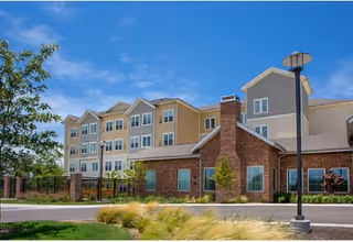 Exterior view of The Delaney at Lake Waco with brick entry and landscaped grounds.