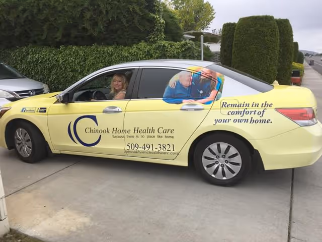 Yellow Chinook Home Health Care car with people inside parked on a driveway.