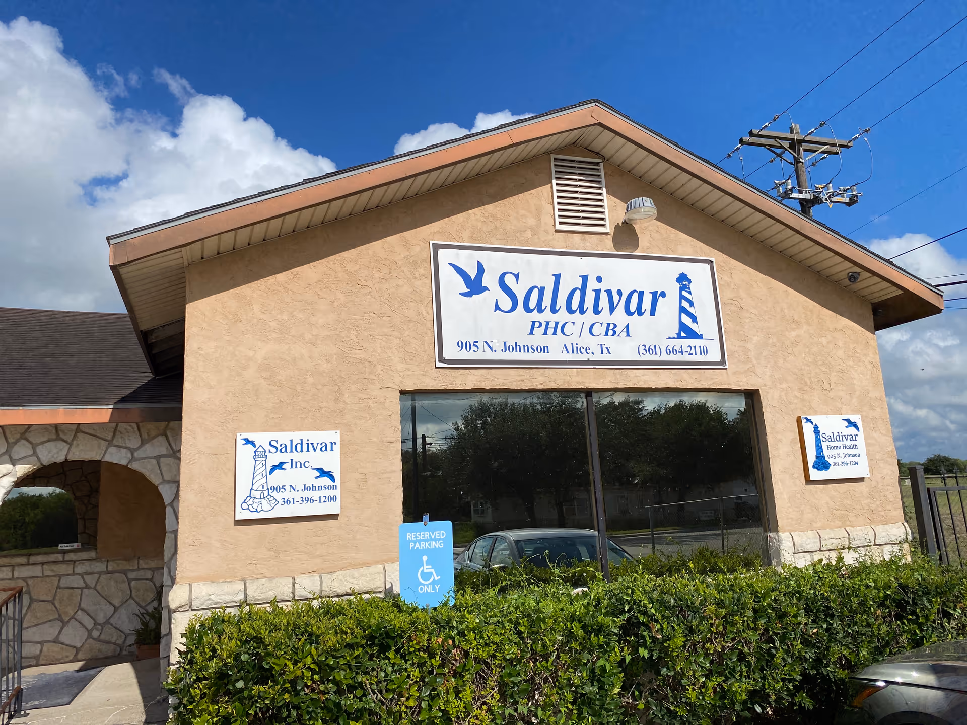 Front view of Saldivar facility building with blue sign and entrance.