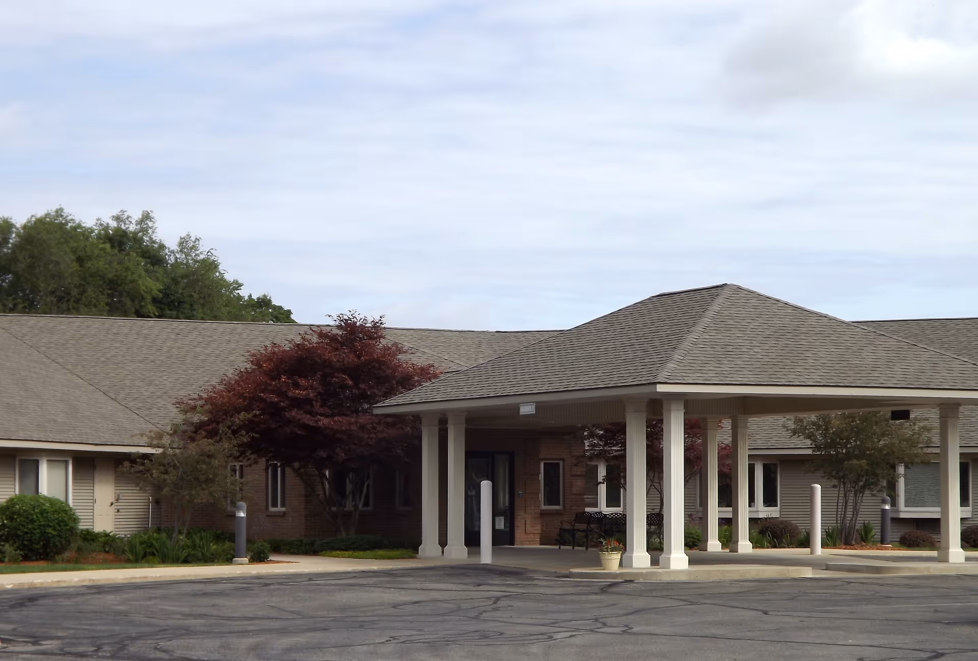 Front entrance of Railside Assisted Living Center with a covered drive-through and brick exterior.