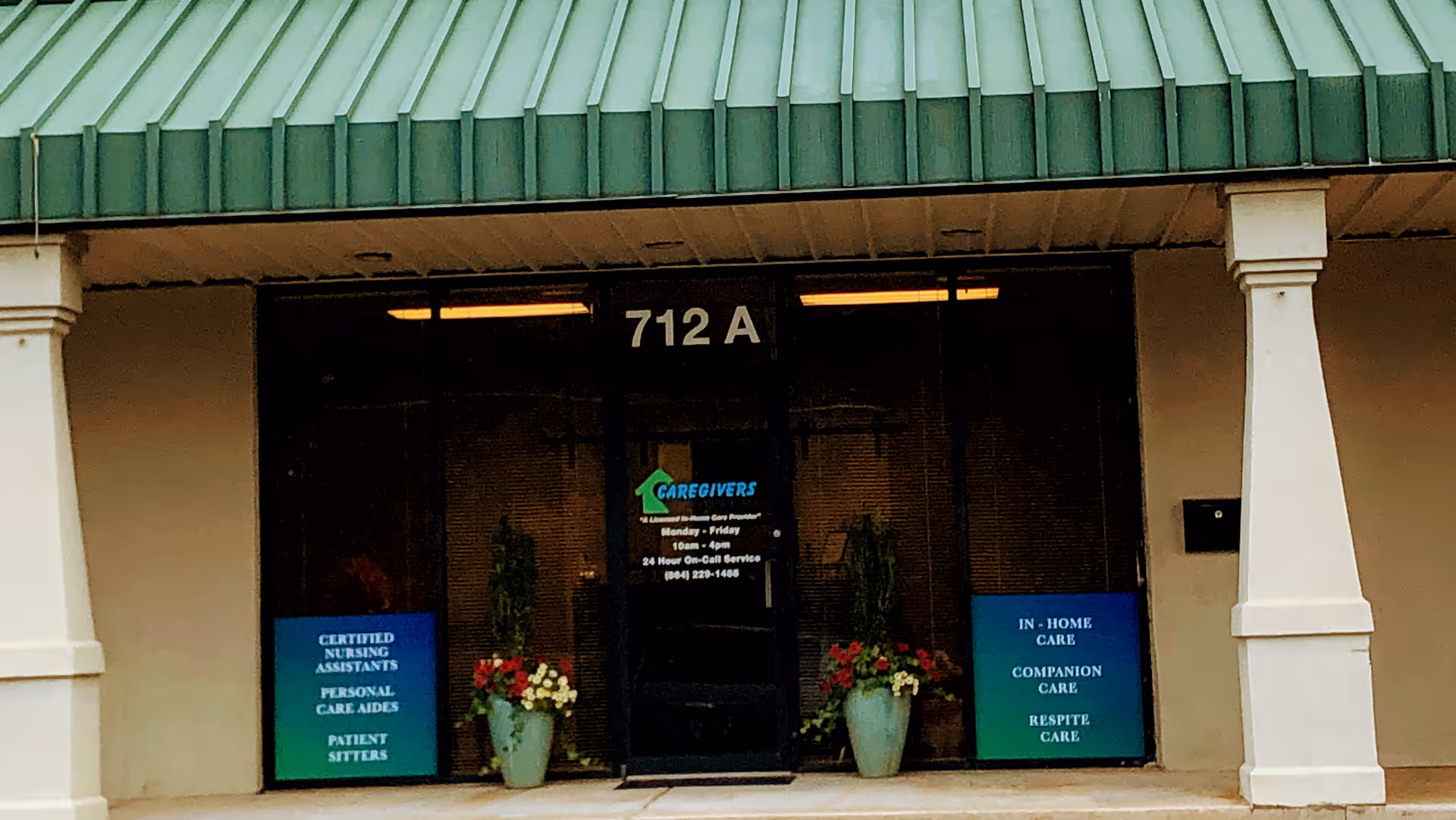 Exterior view of Caregivers of the Upstate entrance with potted plants and banners.