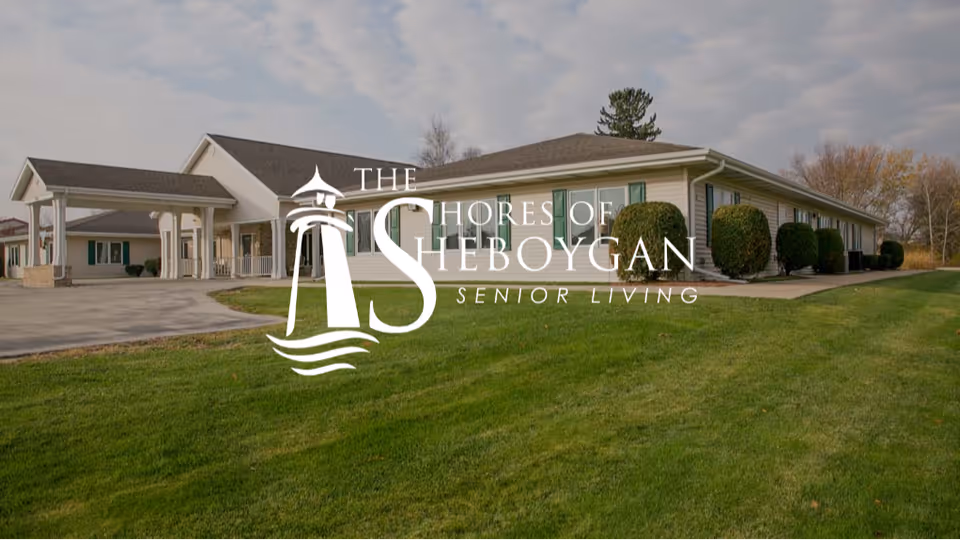 Exterior view of The Shores of Sheboygan senior living building with a green lawn