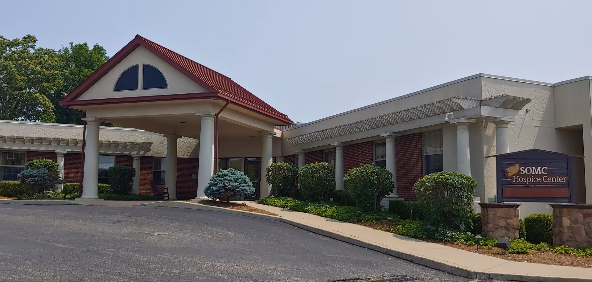 Exterior view of SOMC Hospice Center entrance with a covered drop-off area.