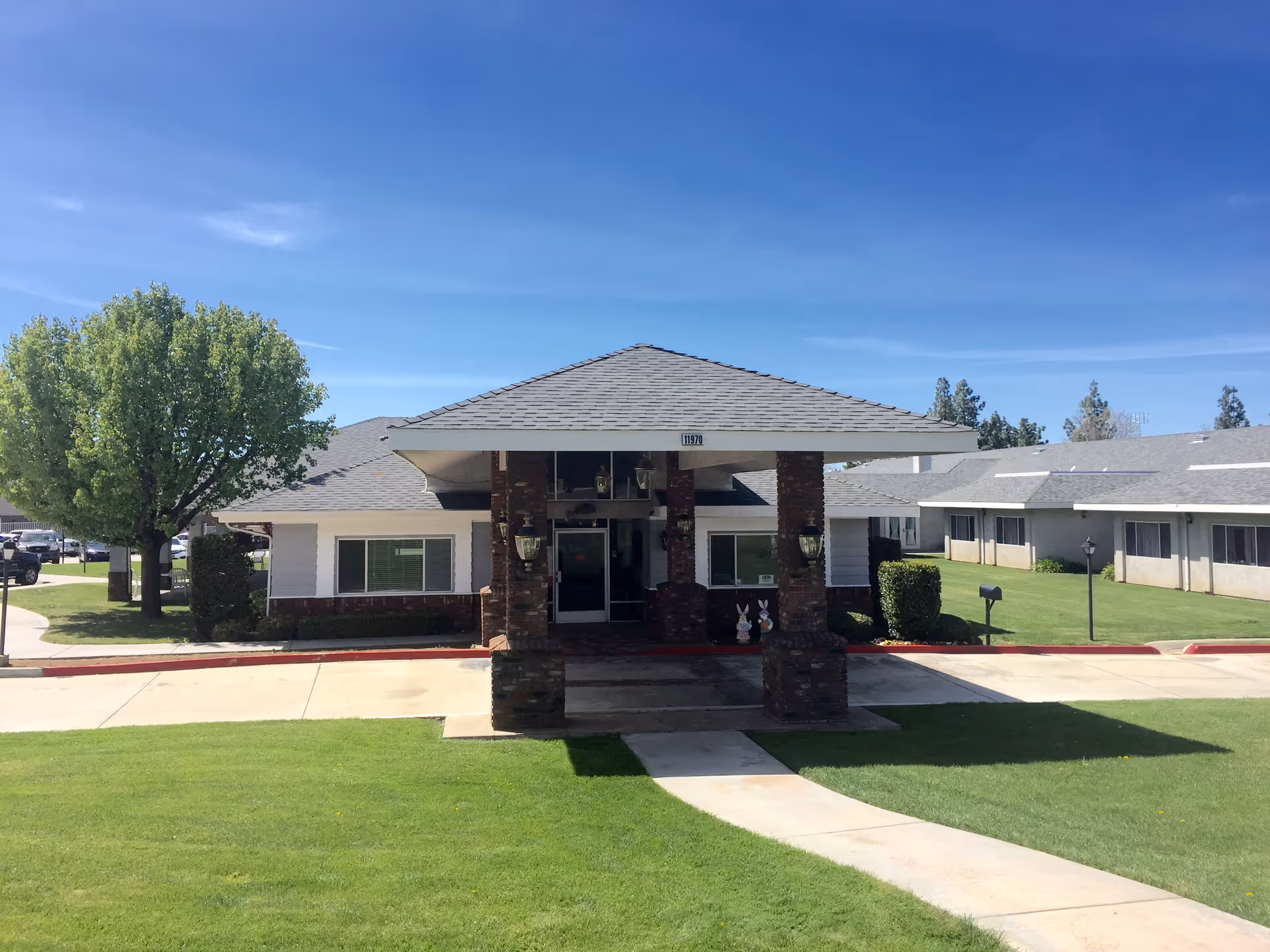 Cedar Mountain Post Acute exterior with entrance, lawn, trees, and covered entry.