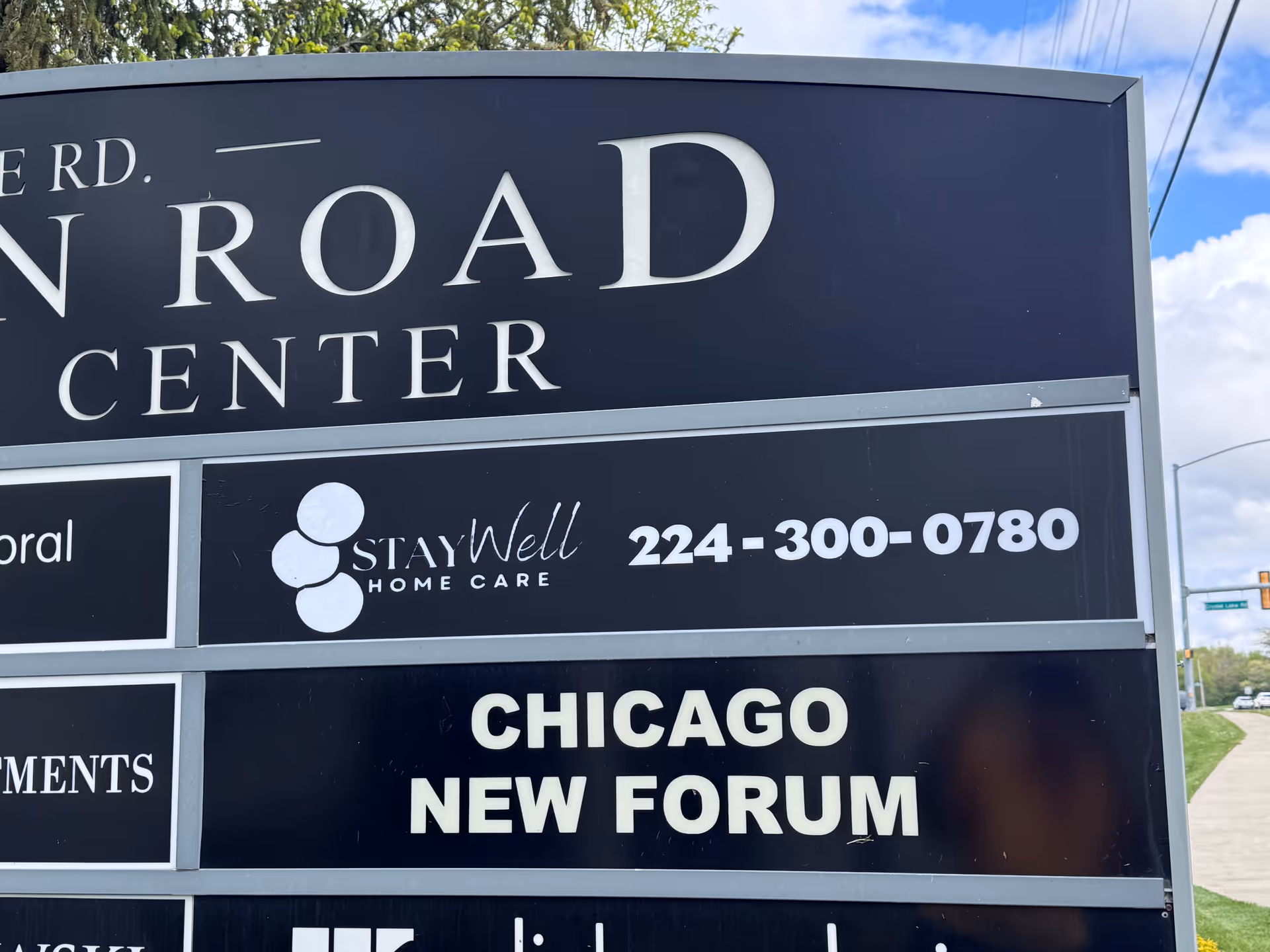 Exterior signboard for StayWell Home Care featuring Chicago New Forum