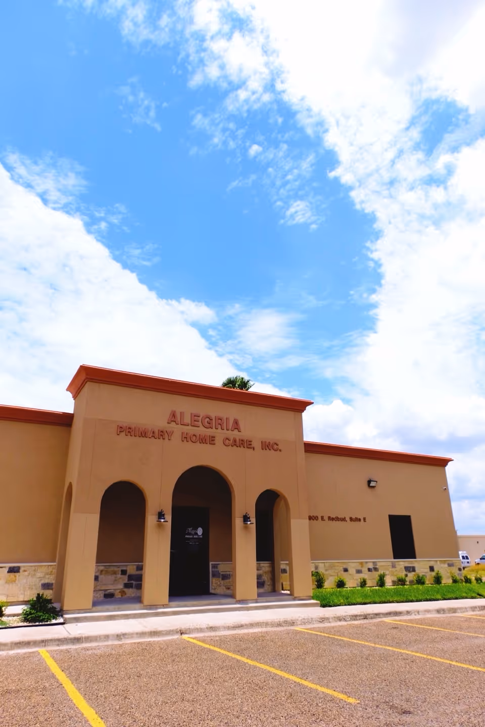 Front exterior of Alegria Primary Home Care building with parking lot