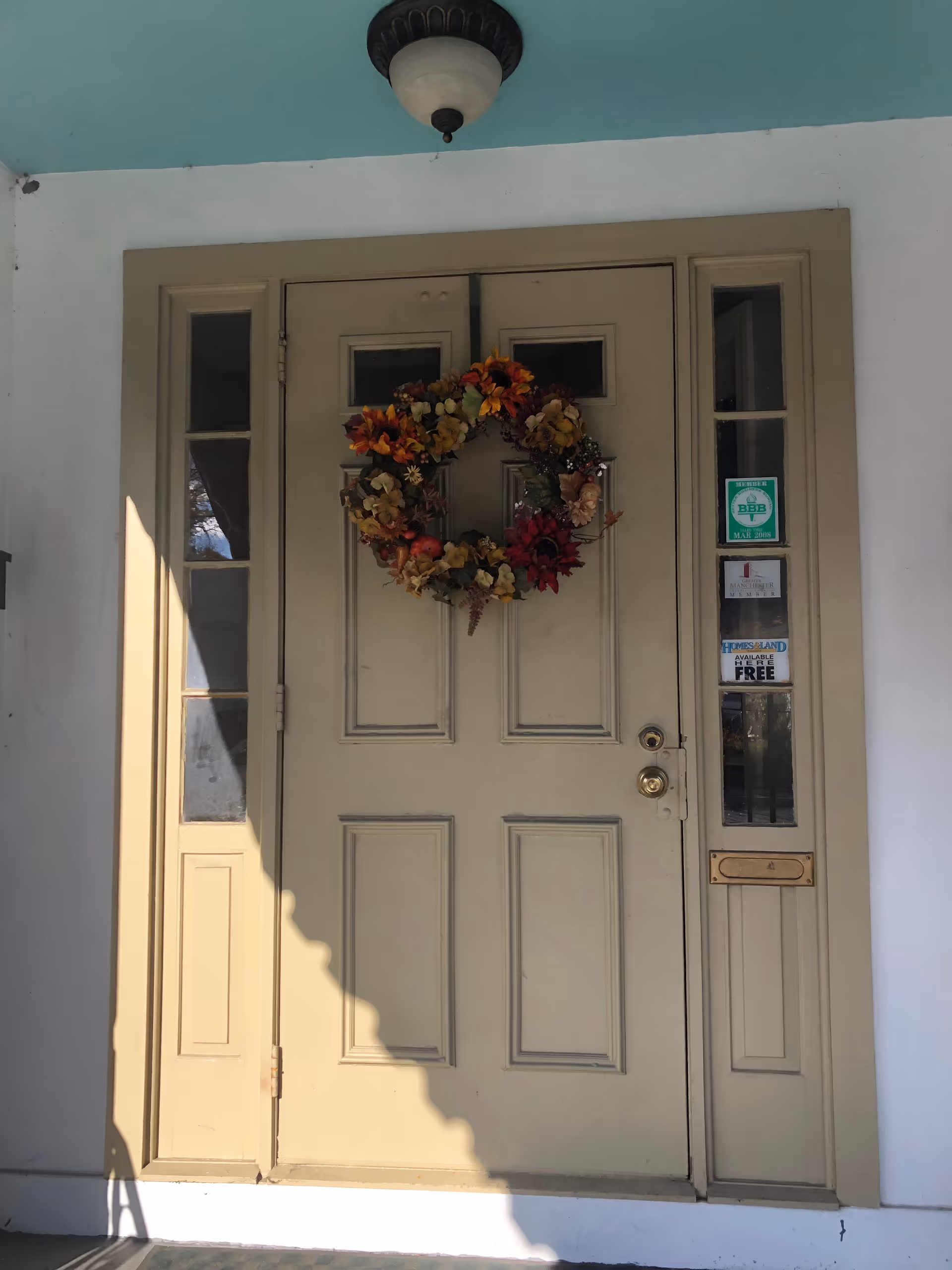 Front entrance of Granite House of Help featuring a fall wreath on the door.