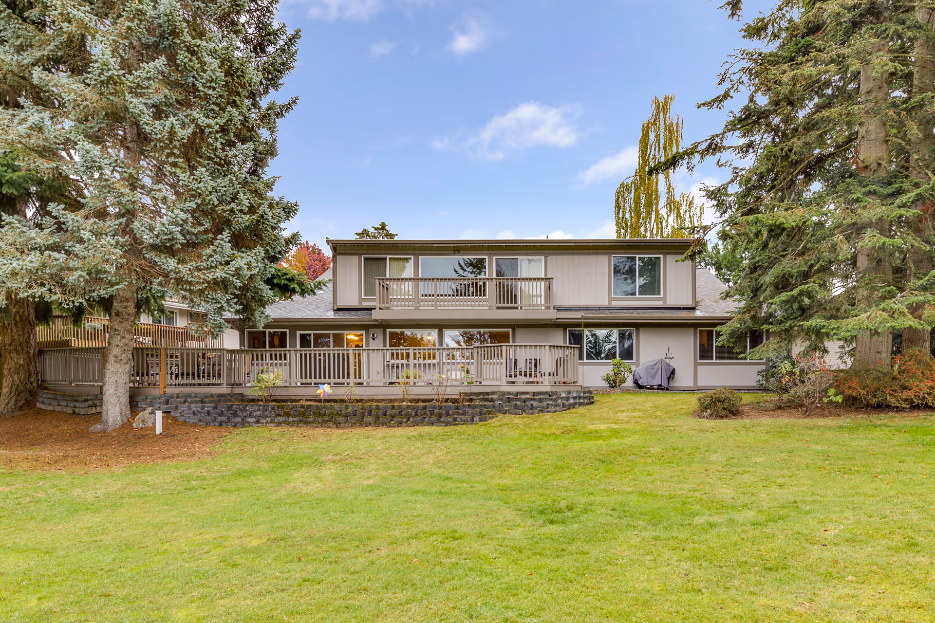 Exterior of Golden Days AFH LLC showing a two-story building with a large deck and lawn.