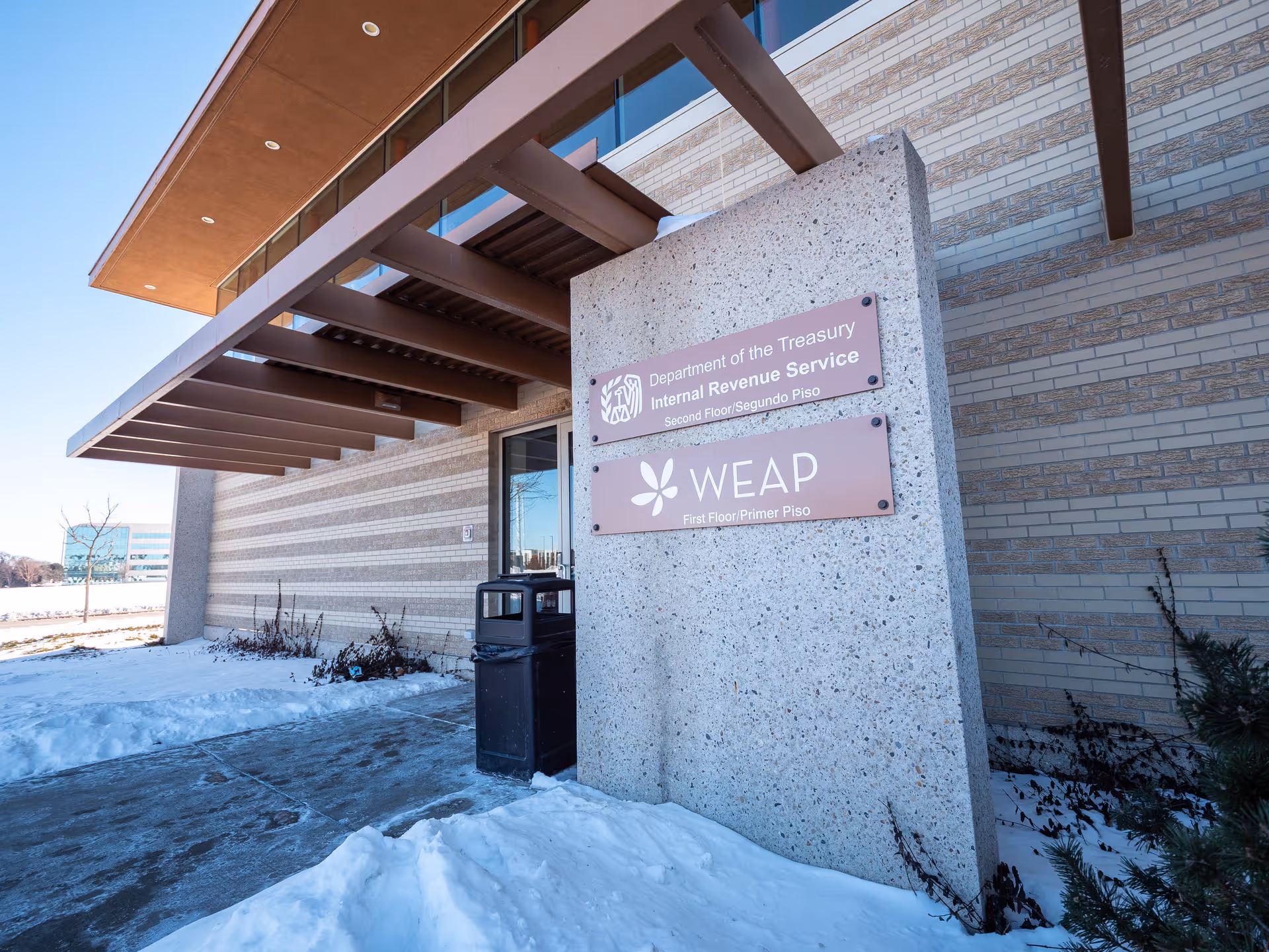 Exterior view of building entrance with WEAP sign and snow