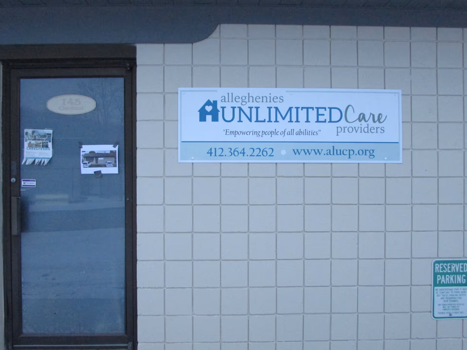 Exterior view of a building front with a sign reading Alleghenies Unlimited Care Providers