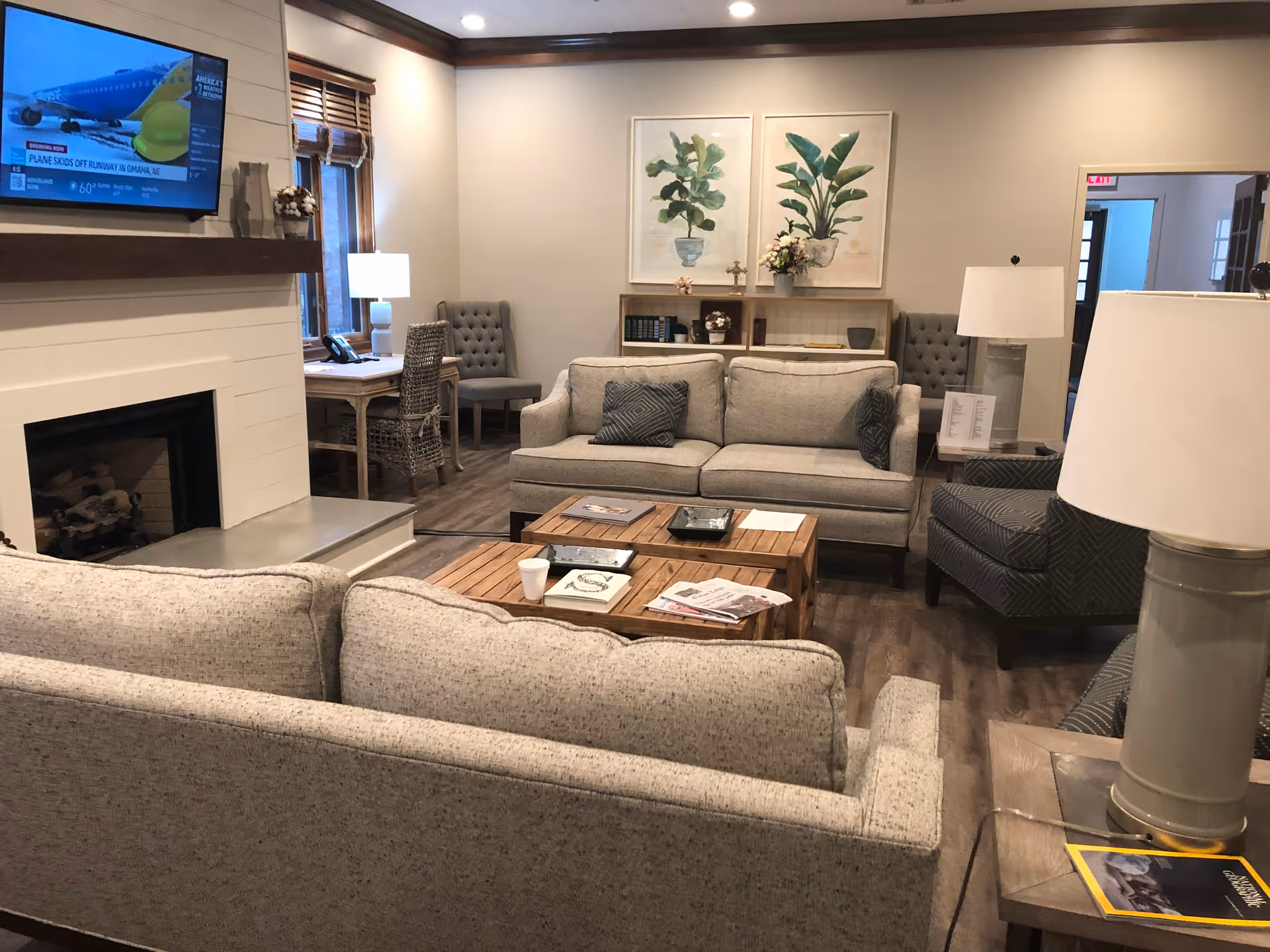 Cozy living room in a senior facility with sofas, a coffee table, and a fireplace.