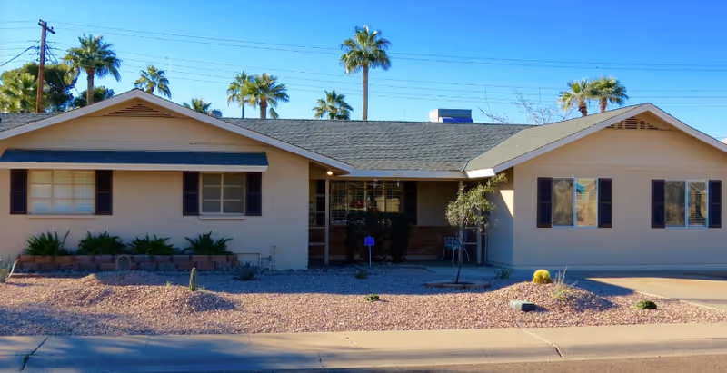 Front exterior of Hazelwood Manor Assisted Living, a single-story building with desert landscaping.