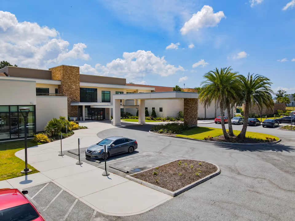 Solaris Healthcare Waterman exterior with circular drive, entrance canopy, and palm trees.