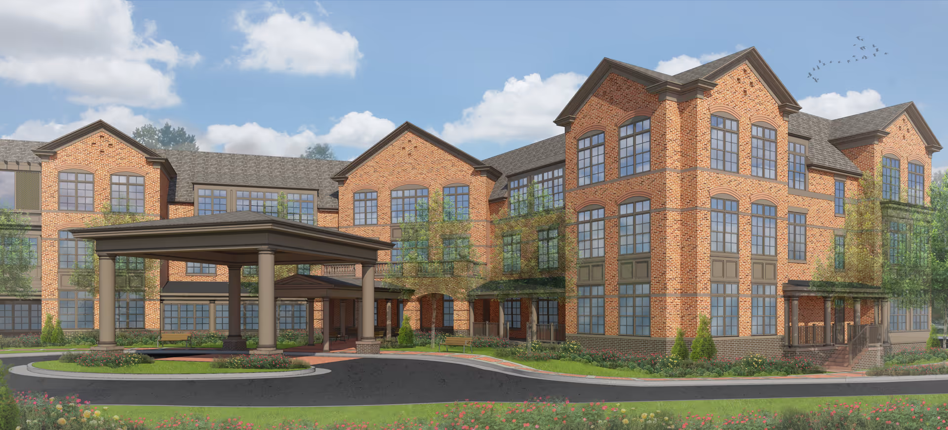 Brick senior living building with a covered entrance and landscaped front driveway.