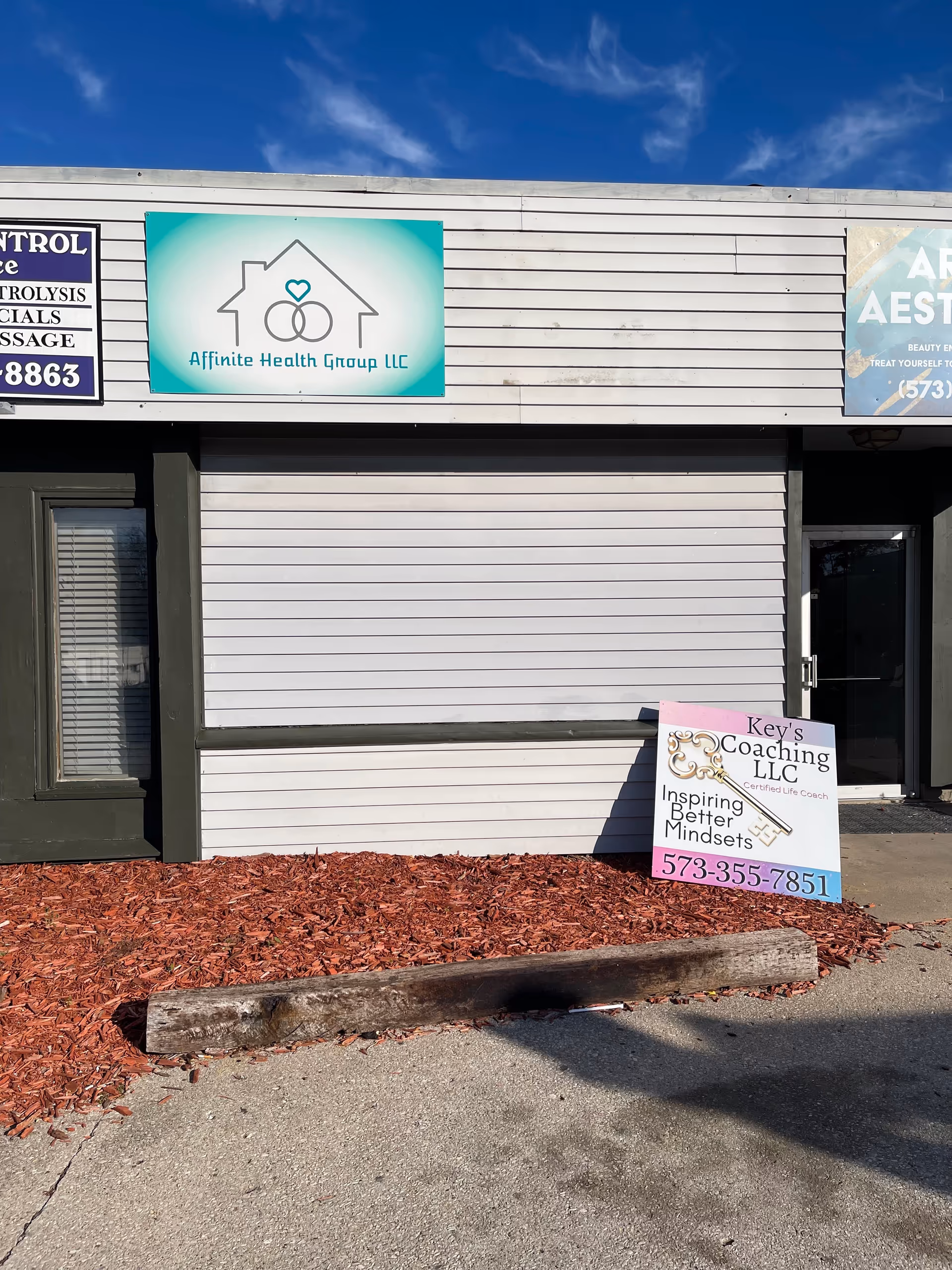 Exterior storefront facade showing Affinite Health Group LLC sign and a coaching sign.