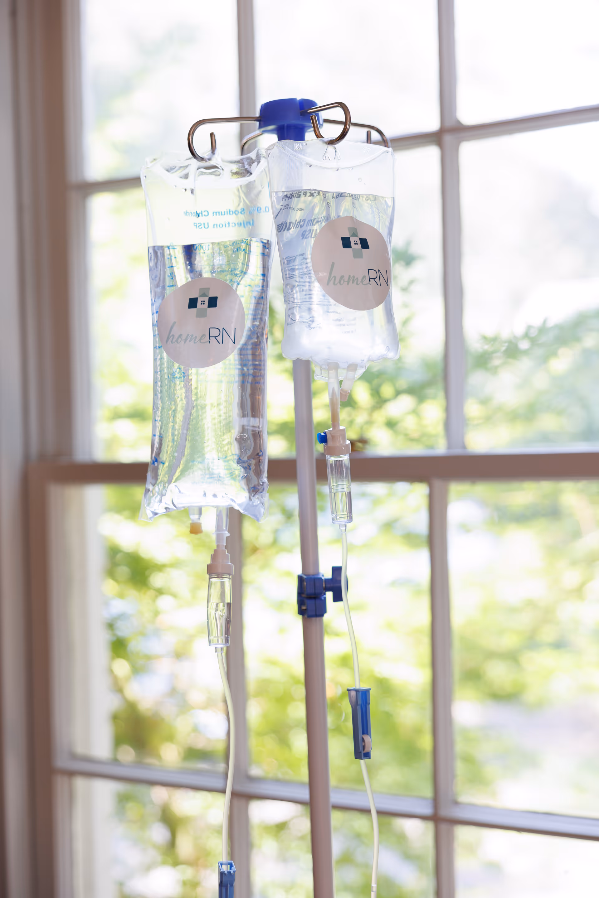 Two IV bags on stands indoors at a homeRN Birmingham senior care facility.