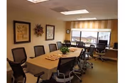 Empty dining room at Holly Heights Nursing Care Center with a long table and chairs.