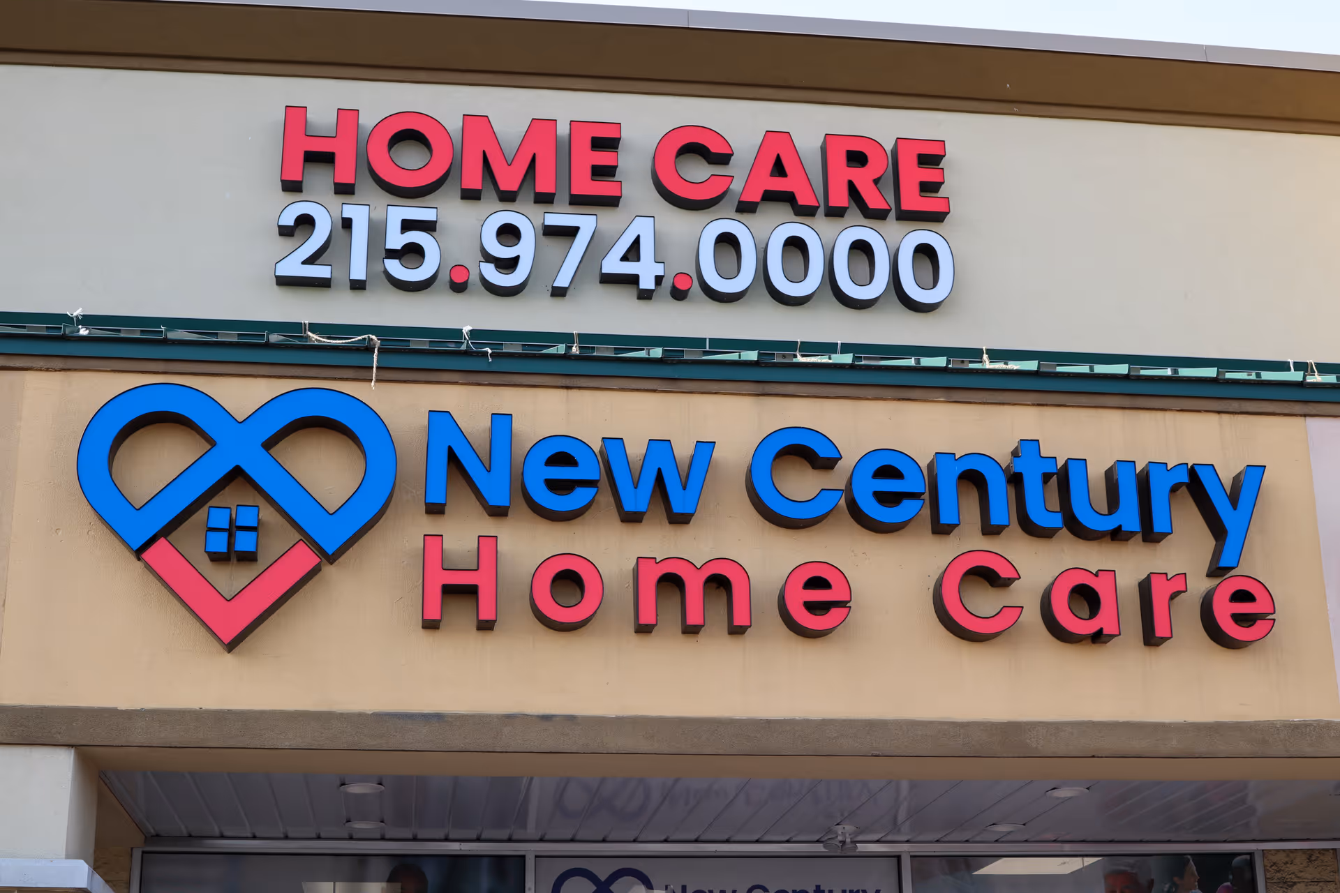 Facade of a senior care facility with large blue and pink New Century Home Care sign.