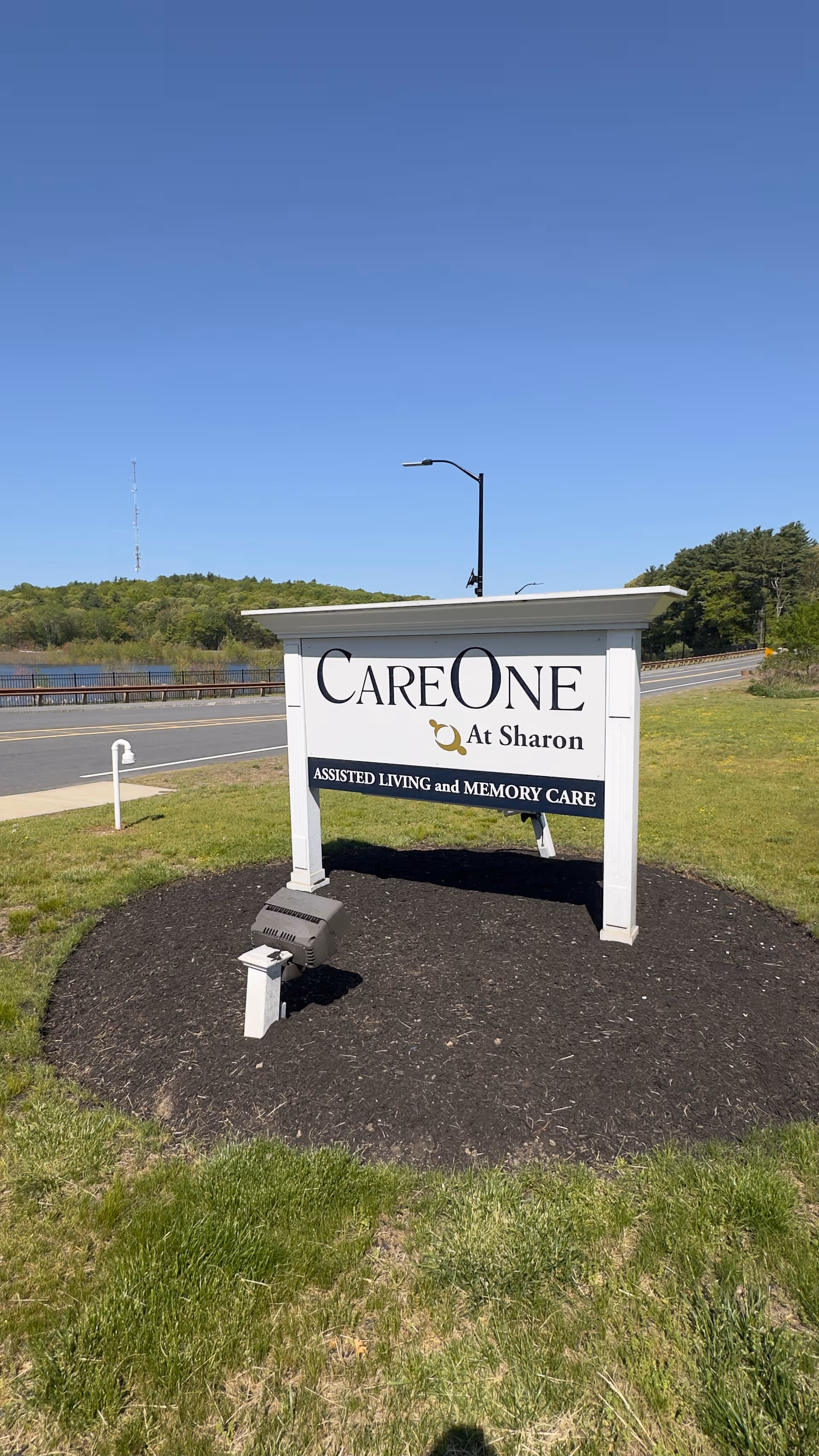 Outdoor roadside sign for CareOne at Sharon advertising assisted living and memory care.