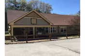 Front view of Alpine Nursing Home, a single-story building with a porch.