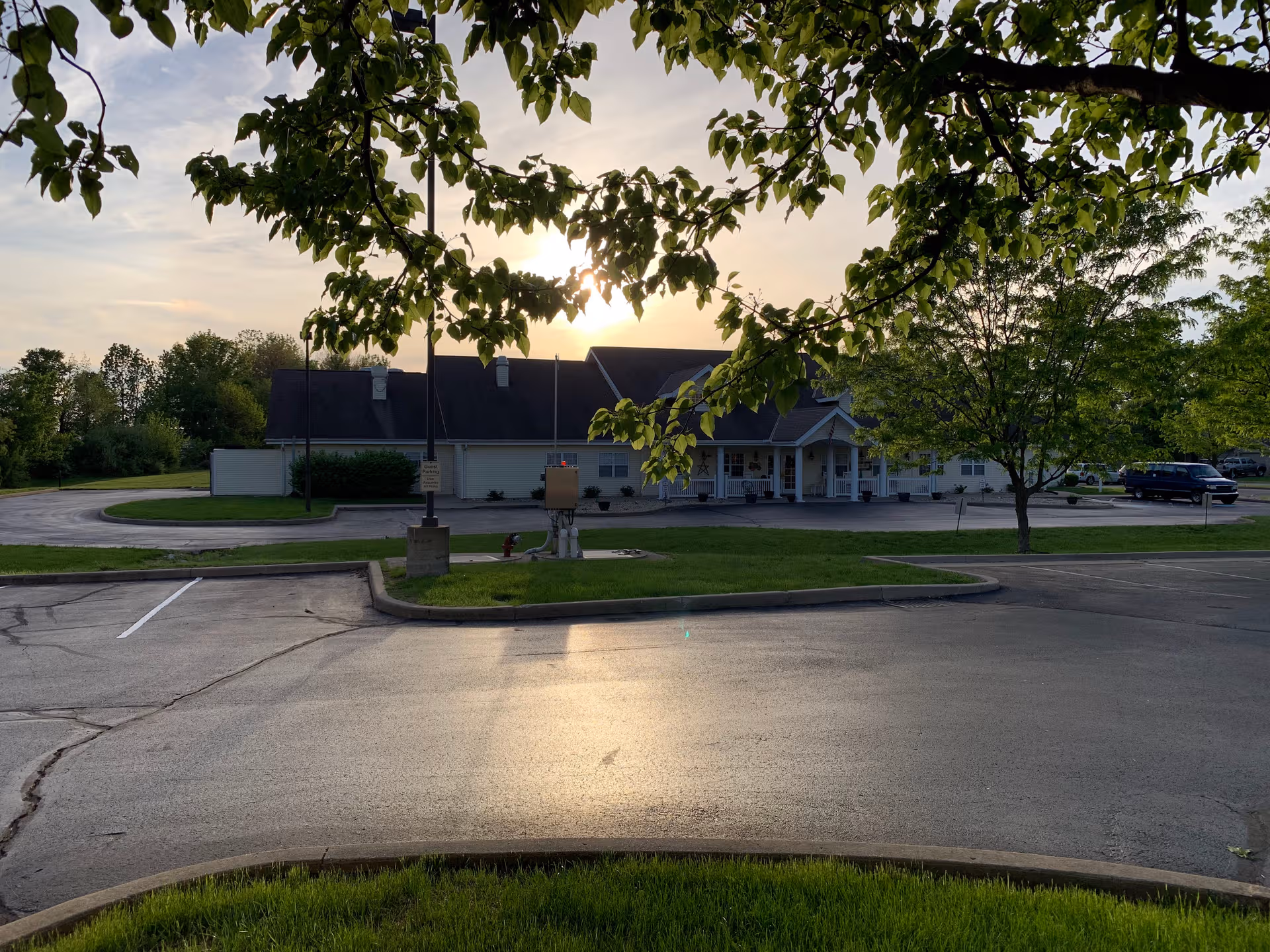 Sunset over Cedar Creek of Seymour's exterior facility with driveway and parking lot.