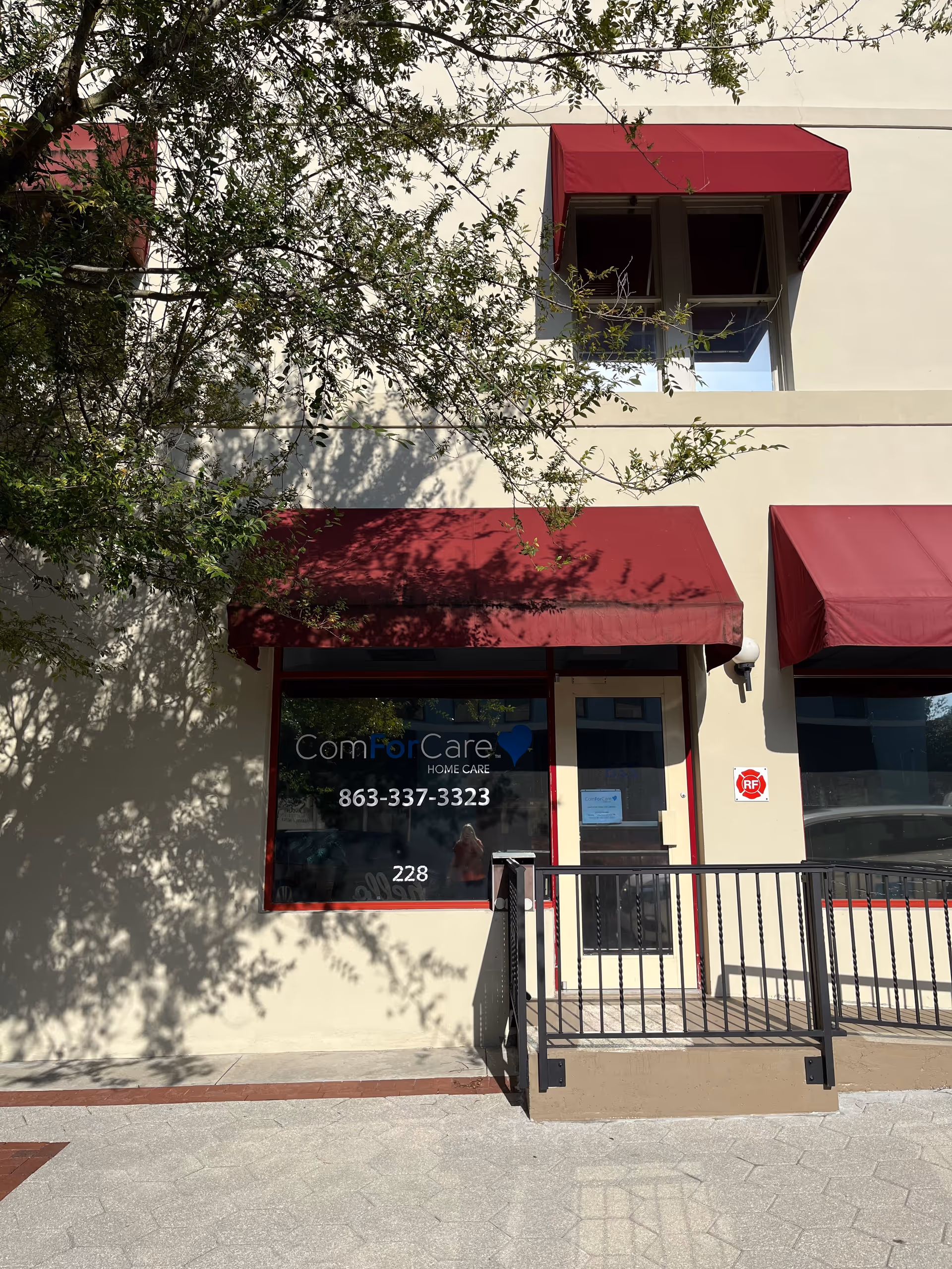 Exterior of ComForCare Home Care Lakeland building with red awnings and accessible entrance.