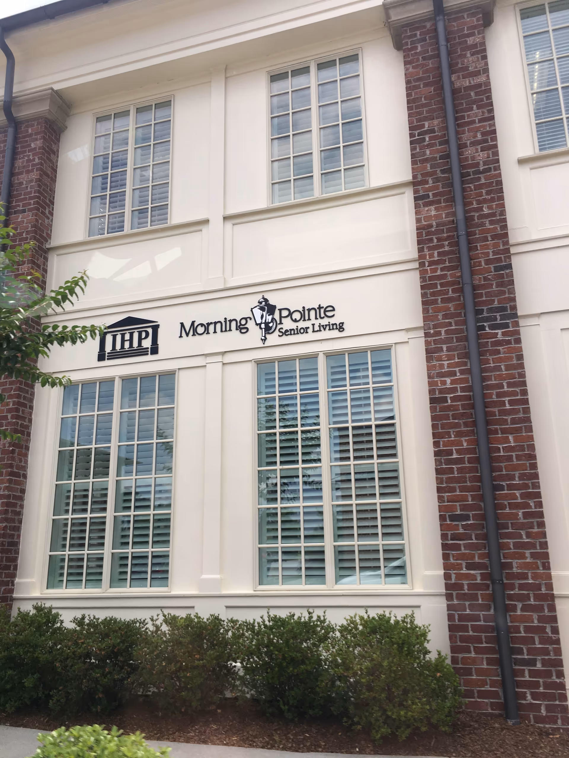Exterior view of Morning Pointe Senior Living building with large windows and signage.