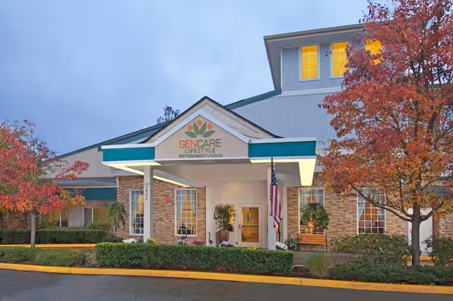 Front entrance of GenCare Lifestyle retirement living facility with flag and trees