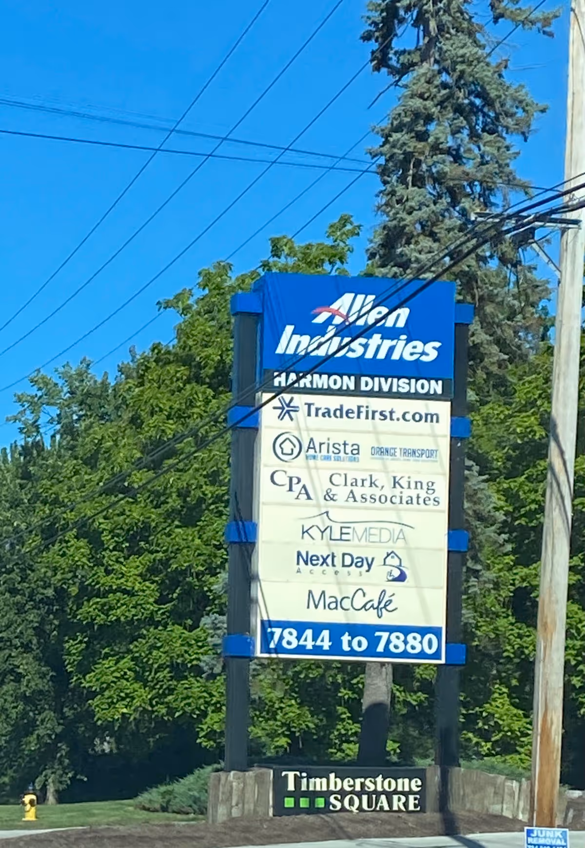 Tall outdoor signboard featuring Arista Home Care Solutions among other business logos.