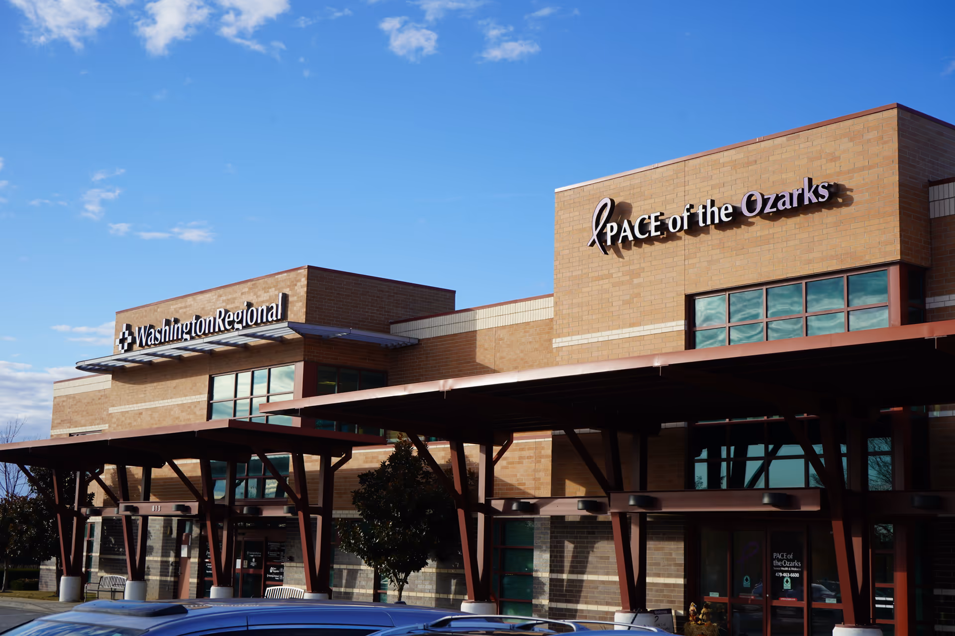 Exterior view of a brick senior care facility with PACE of the Ozarks sign.