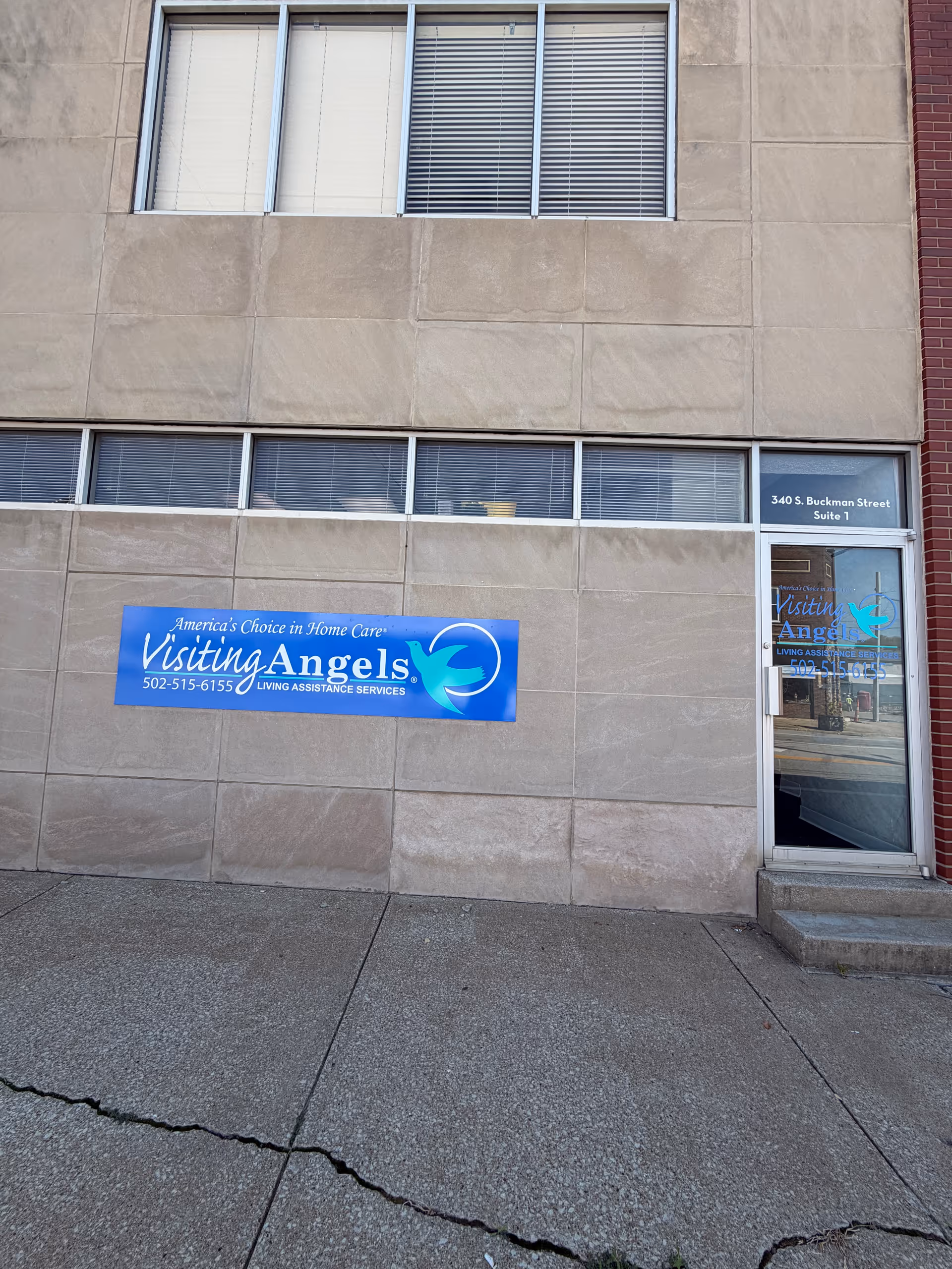Exterior view of Visiting Angels Senior Home Care Shepherdsville building with blue sign.