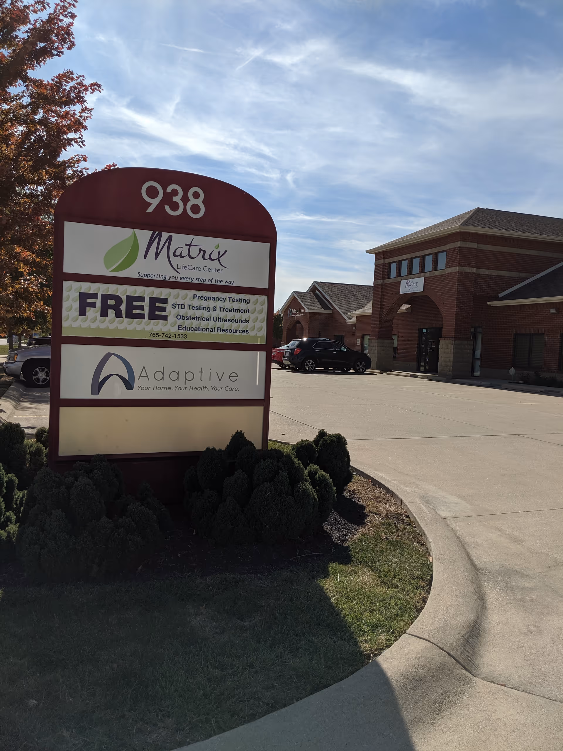 Exterior of a brick medical facility with a large sign reading Adaptive Nursing and Healthcare Services.