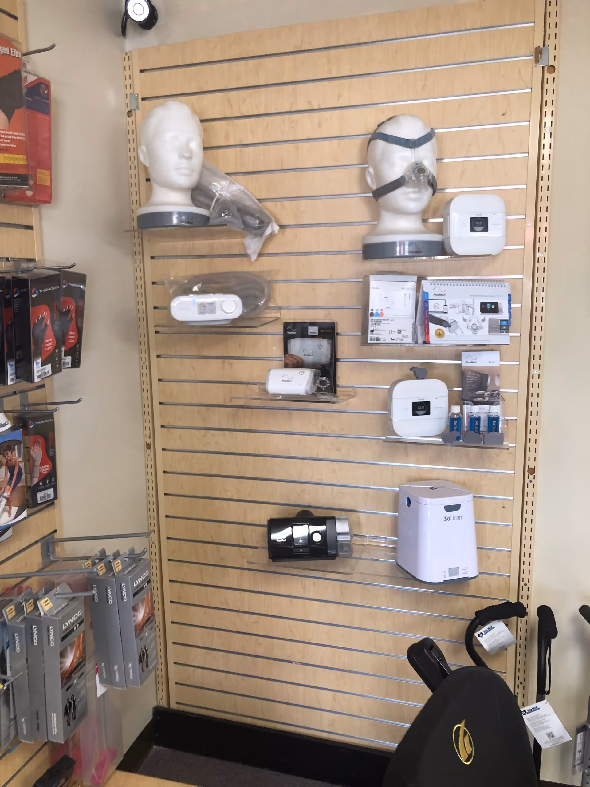 A wall of medical devices displayed on a slatwall in a store showroom.